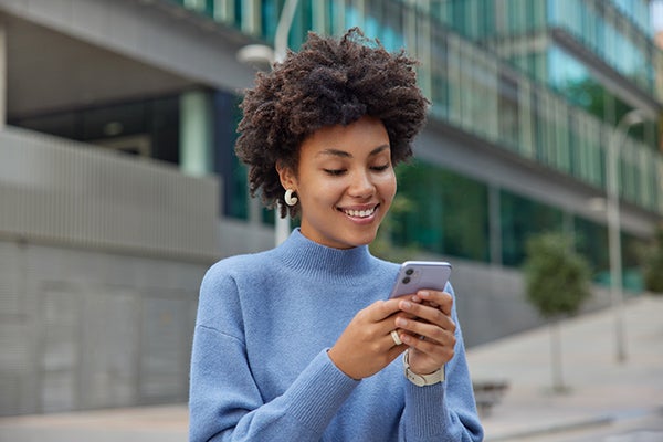 woman on cell phone texting, buckeye text message sign up