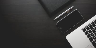 black and white photo of devices on a desk
