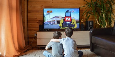 kids sitting on floor watching tv