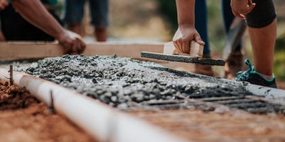 group of people laying concrete foundation