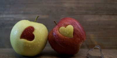 photo of green apple with red apple heart and red apple with green apple heart