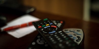 pile of tv remotes on a coffee table