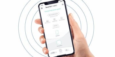 image of hand holding phone with smartnet app open