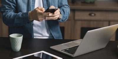 home wifi tips, improve home wifi, man with computer and smartphone