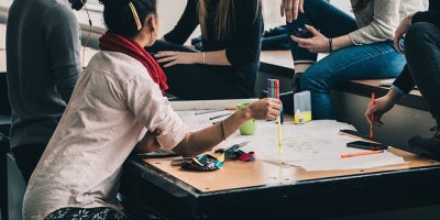 group of students gathered around a table studying