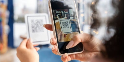 buckeye blog, qr code scams, woman scanning qr code