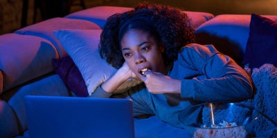 buckeye blog, best scifi movies, woman watching movie eating popcorn