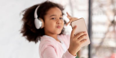 parental control apps, bark, life360, little girl doing selfie