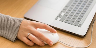how fast is my internet, download speed, persons hand on mouse near laptop