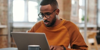 Man working on laptop trying to choose internet provider