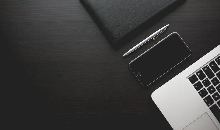 black and white photo of devices on a desk