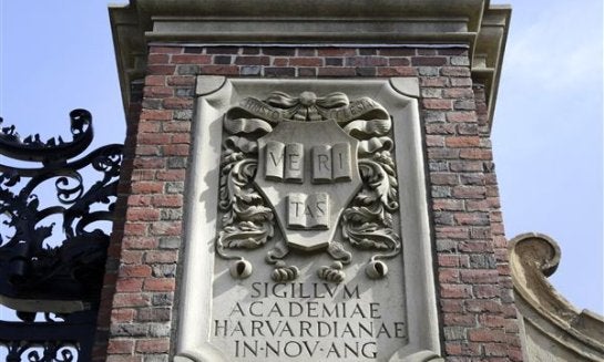 A relief sculpture rests on a gate to the entrance of Harvard University, in Cambridge, Mass., in 2016.