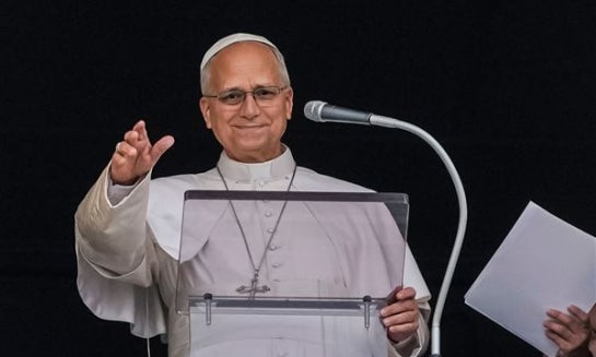 Pope Leo XIV appears at the window of his study in the Apostolic Palace overlooking St. Peter's Square at the Vatican for the traditional noon blessing after praying the Angelus Oct. 18 a day after he returned from the hospital, where he had lung cancer r