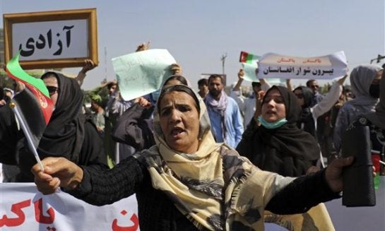 Afghan women shout slogans during an anti-Pakistan demonstration, near the Pakistan embassy in Kabul, Afghanistan, Tuesday, Sept. 7, 2021. The framed sign in Persian reads, "Freedom."