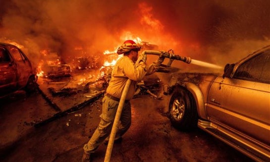 An emergency vehicle drives through a neighborhood burned by the Eaton Fire in 2025, in Altadena, Calif.