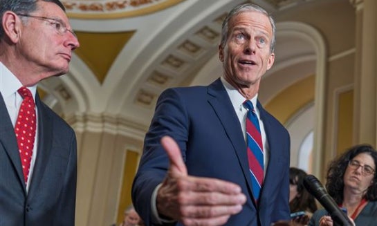 Senate Majority Leader John Thune, R-S.D., joined at left by Sen. John Barrasso, R-Wyo., speaks to reporters after a closed-door meeting with fellow Republicans on Dec. 9 at the Capitol in Washington.