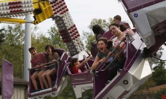 Mackenzie Berry, 12, center, screamed as she and her friend McKenze McDrew, 12, both of Sylvania, rode the Orbiter during the 34th Annual Festirama carnival at St. Joseph Church and School in Sylvania in 2013.