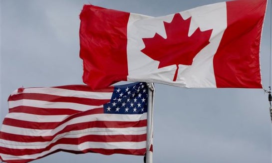 The flags of Canada and the United States fly in Ottawa on Sept. 12.