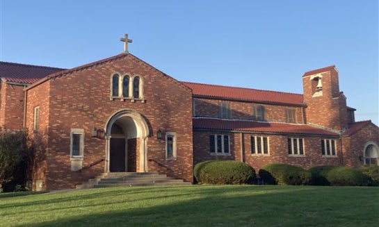 A pastor greets families at Faith Lutheran Church.