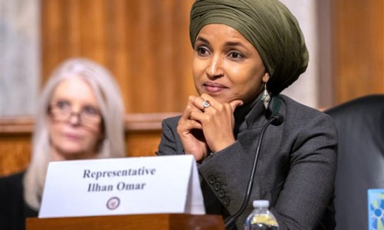 Community members rally in support of Democratic Rep. Ilhan Omar, D-Minn., on Oct. 12 at Powderhorn Park in Minneapolis.