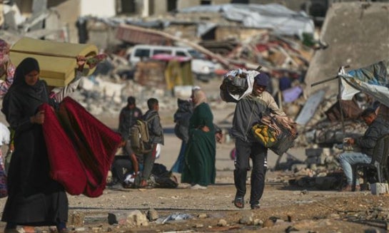 A man Palestinian man carries bags of firewood after collecting them from the rubbish in Khan Younis, southern Gaza Strip, on Nov. 15.