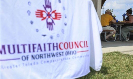 Chuck Stocking, member of the finance committee, and Angie Fitzpatrick, program manager of the MultiFaith Council of Northwest Ohio, chat during an annual picnic at the Glass City Metropark in Toledo on Sunday, Aug. 10, 2025.