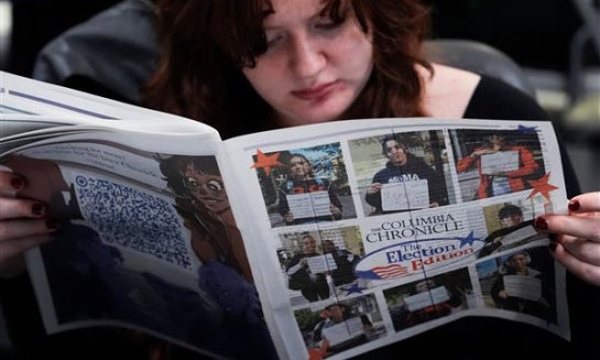 Columbia College Chicago student Kailey Ryan reads a newspaper in Chicago on Nov. 5, 2024.