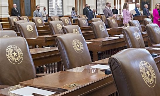 Empty chairs belonging to House Democrats remain empty during a session convocation in the State Capitol on Aug. 5 in Austin.