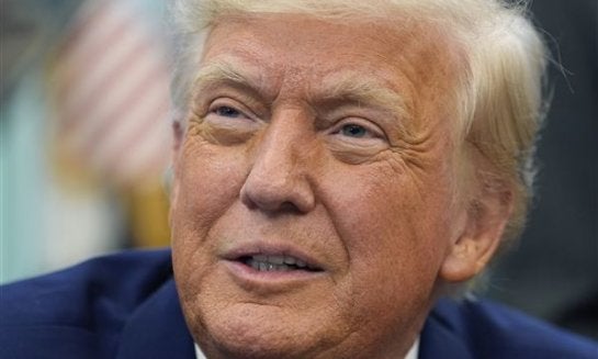 President Donald Trump speaks with reporters as he signs an executive order in the Oval Office of the White House May 9 in Washington.