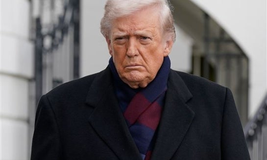President Donald Trump talks to reporters as he departs from the South Lawn of the White House on Dec. 13 in Washington.