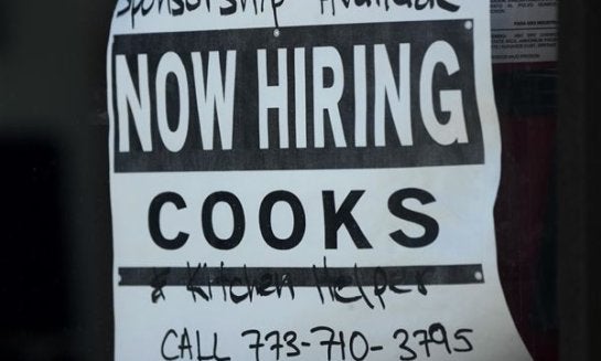 A hiring sign is displayed at a restaurant in Chicago, March 11. On April 25, the Labor Department reports on the number of people who applied for unemployment benefits last week.