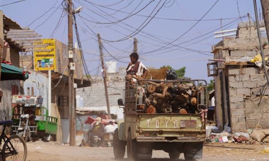 A truck loaded with firewood drives through the Al-Basateen neighborhood in Aden, Yemen, on Oct. 13.