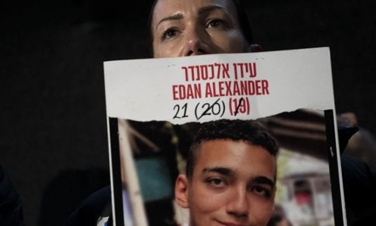 Yael Alexander holds a poster of her son, Edan, who was taken hostage by Hamas militants on Oct. 7, 2023, during a weekly rally for families of hostages held in the Gaza Strip and their supporters, in Tel Aviv, Israel, Feb. 22.