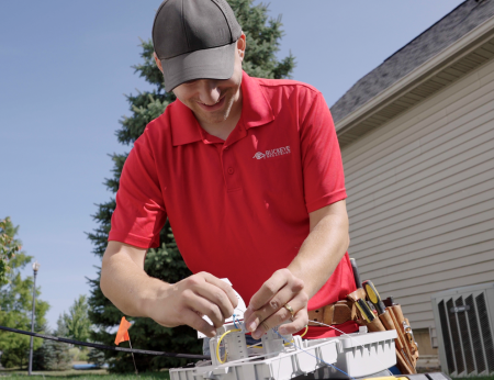 install tech connecting fiber internet lines outside a home