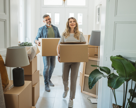 Couple moving boxes in home