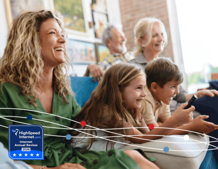 family laughing on couch - high speed internet award logo 
