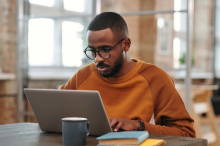 Man working on laptop trying to choose internet provider