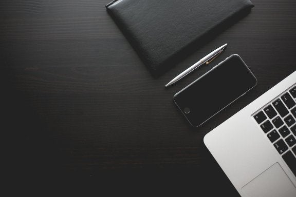 black and white photo of devices on a desk