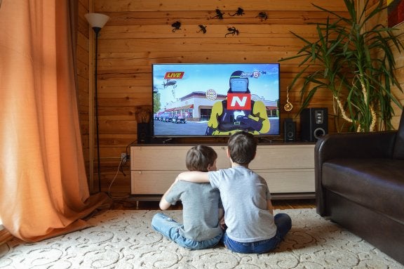 kids sitting on floor watching tv