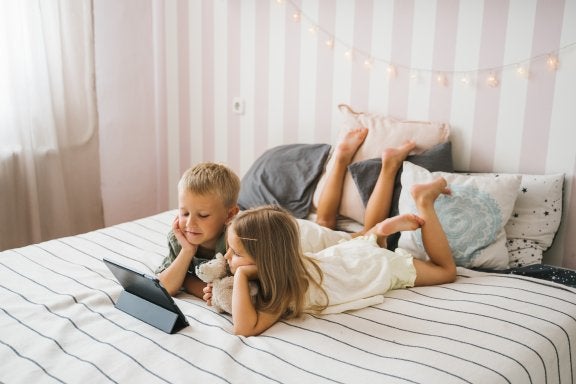 photo of two children sharing and watching a tablet