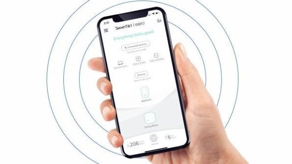 image of hand holding phone with smartnet app open