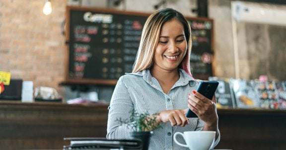 business wifi, free guest wifi, customer wifi, woman in cafe on phone