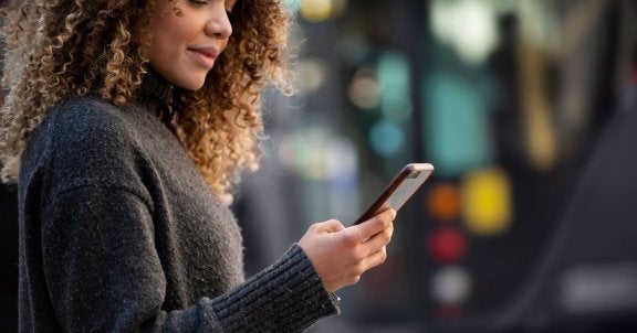 what is a mobile hotspot, how does a hotspot work, woman on phone outside