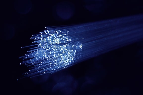 The hair-thin glass interior of a fiber-optic cable used for fiber internet