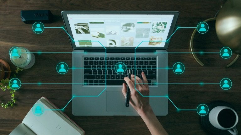 photo of laptop from above with overlay of interconnected network