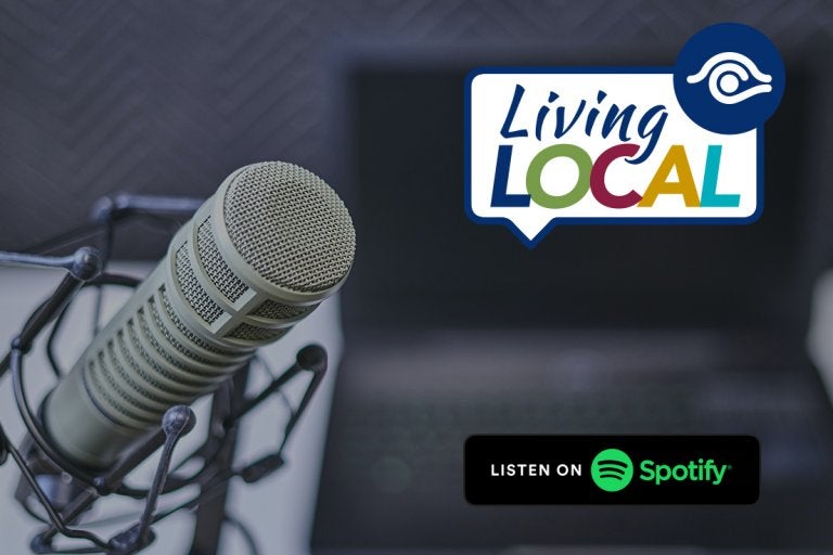 photo of microphone with living local logo and listen on spotify logo