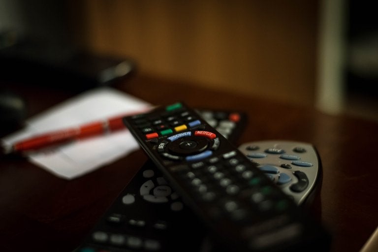 pile of tv remotes on a coffee table