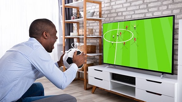 Man watching soccer game holding a ball, live sports streaming, sports tv streaming