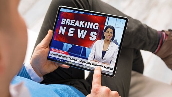 News anchor next to "Breaking News" call