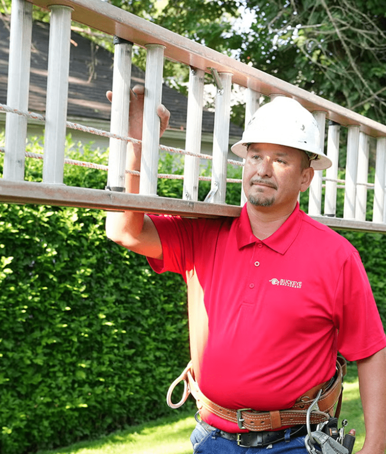 Buckeye employee carrying a ladder on his shoulder